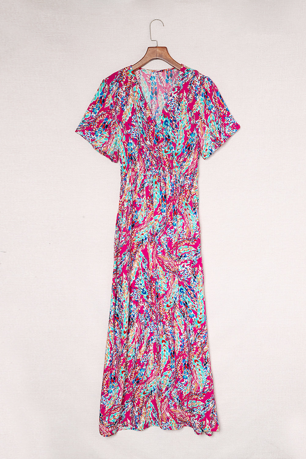 A beautiful woman wearing a Wrap V Neck Floral Maxi Dress with a vibrant floral print, flutter sleeves, and a flattering silhouette, perfect for summer occasions.