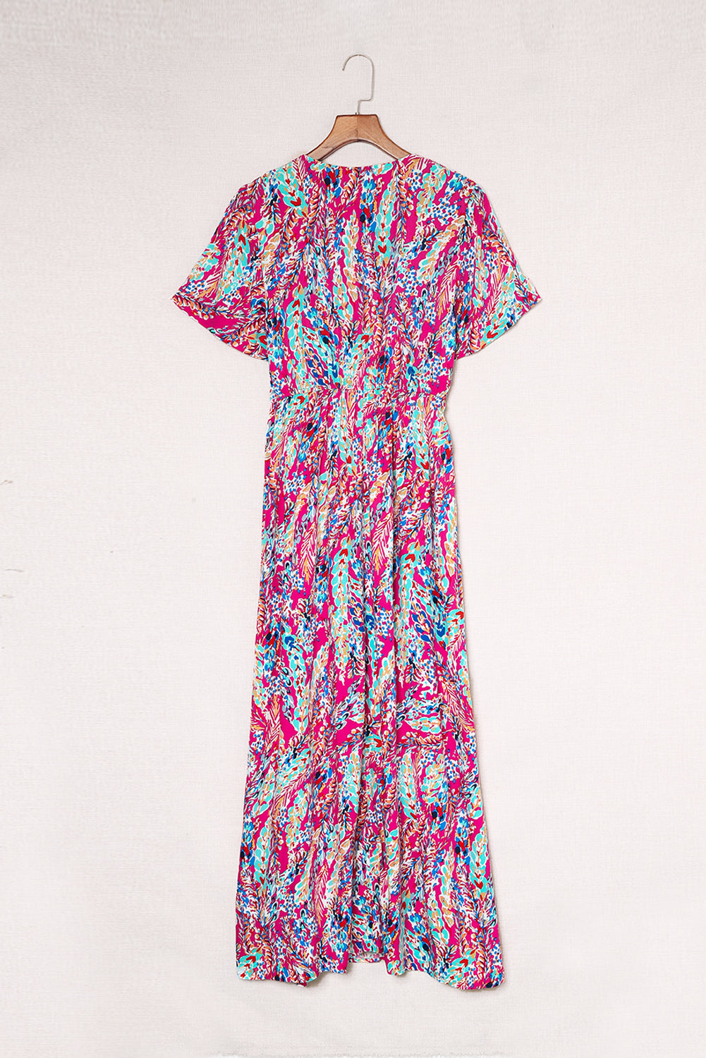 A beautiful woman wearing a Wrap V Neck Floral Maxi Dress with a vibrant floral print, flutter sleeves, and a flattering silhouette, perfect for summer occasions.