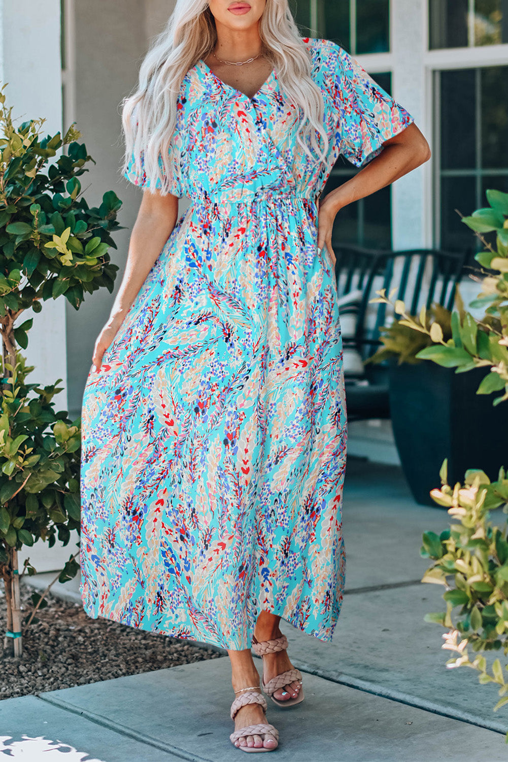 A stylish Wrap V Neck Floral Maxi Dress featuring a vibrant floral print, flutter sleeves, and a flattering wrap design, perfect for summer occasions.