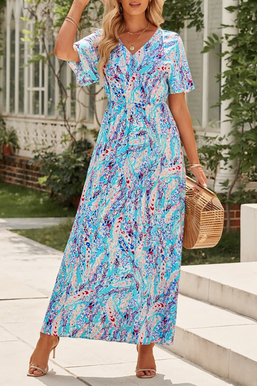 A stylish Wrap V Neck Floral Maxi Dress featuring a vibrant floral print, flutter sleeves, and a flattering wrap design, perfect for summer occasions.