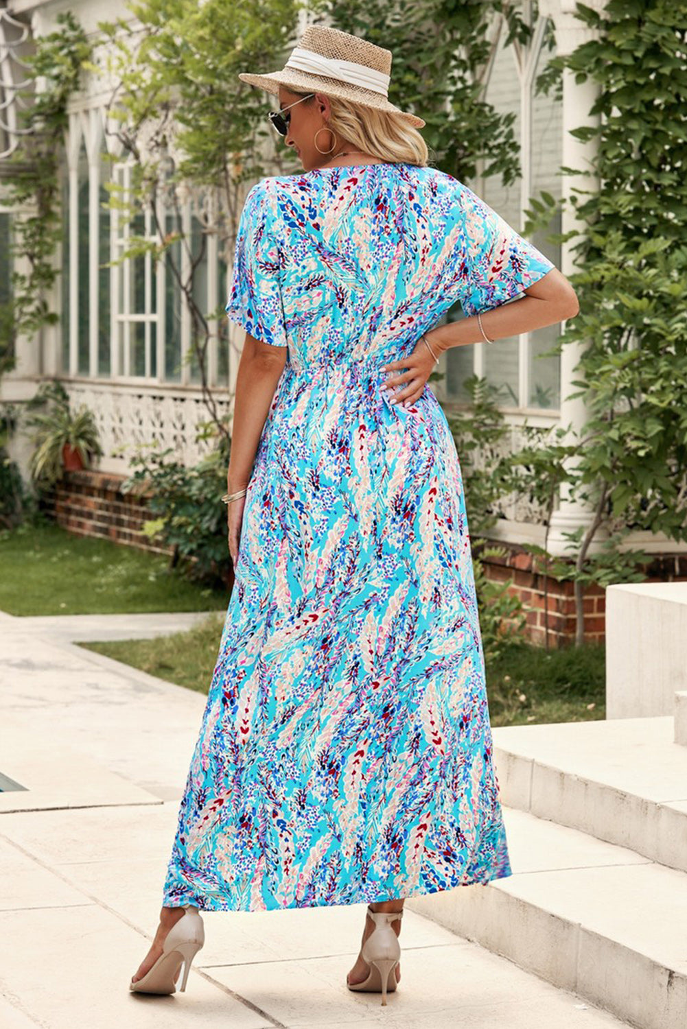 A stylish Wrap V Neck Floral Maxi Dress featuring a vibrant floral print, flutter sleeves, and a flattering wrap design, perfect for summer occasions.