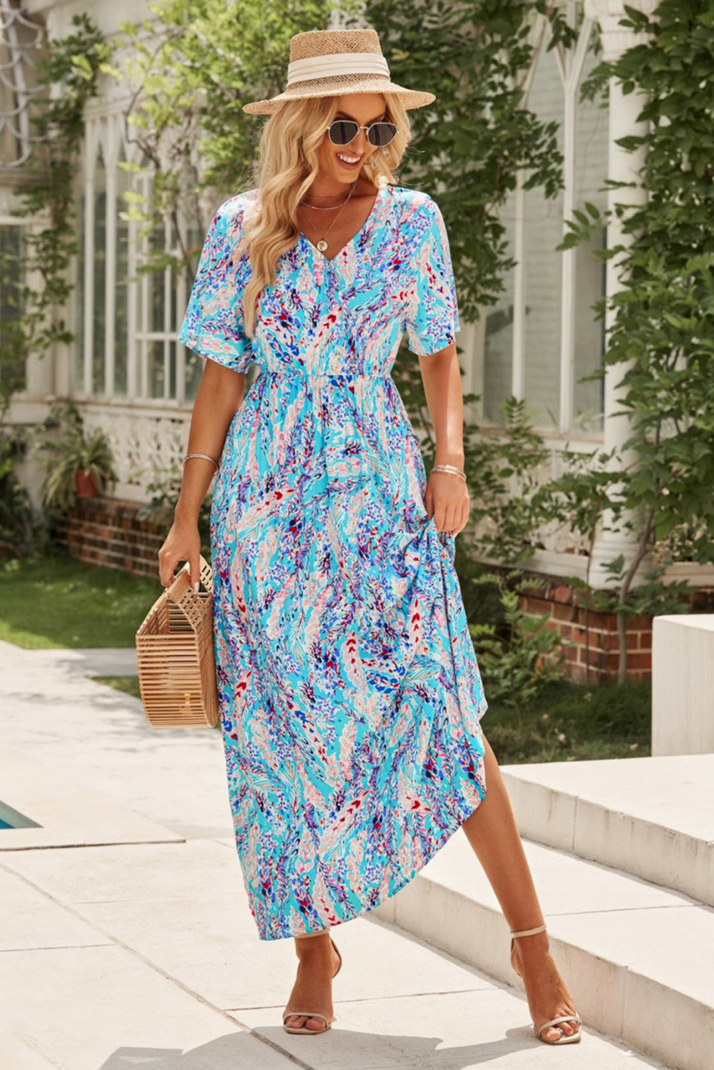 A stylish Wrap V Neck Floral Maxi Dress featuring a vibrant floral print, flutter sleeves, and a flattering wrap design, perfect for summer occasions.