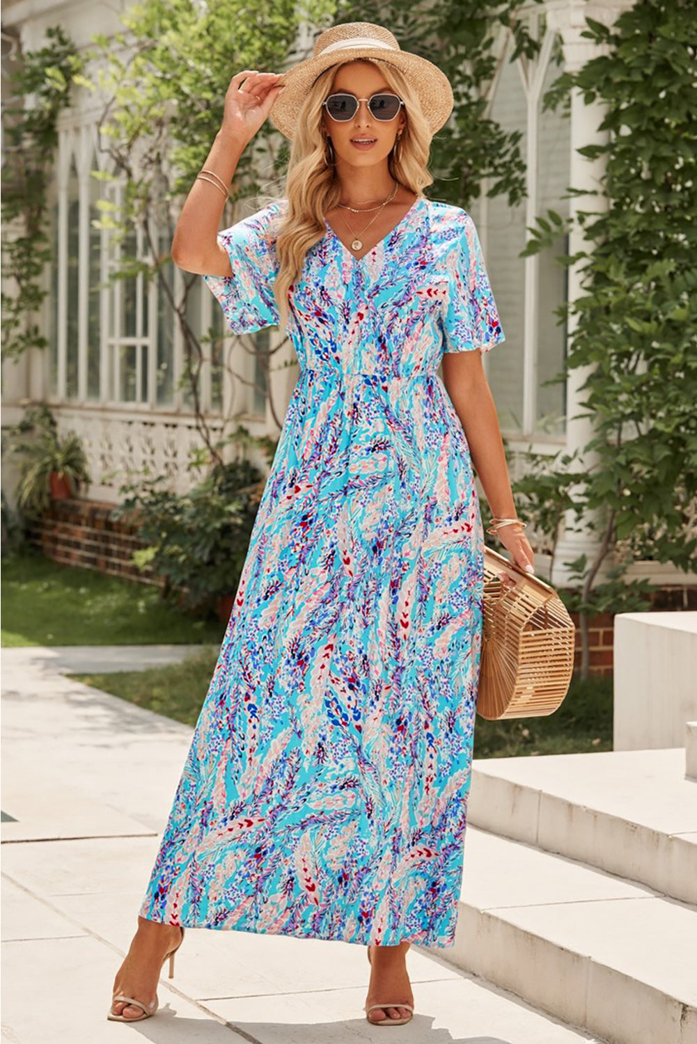 A stylish Wrap V Neck Floral Maxi Dress featuring a vibrant floral print, flutter sleeves, and a flattering wrap design, perfect for summer occasions.