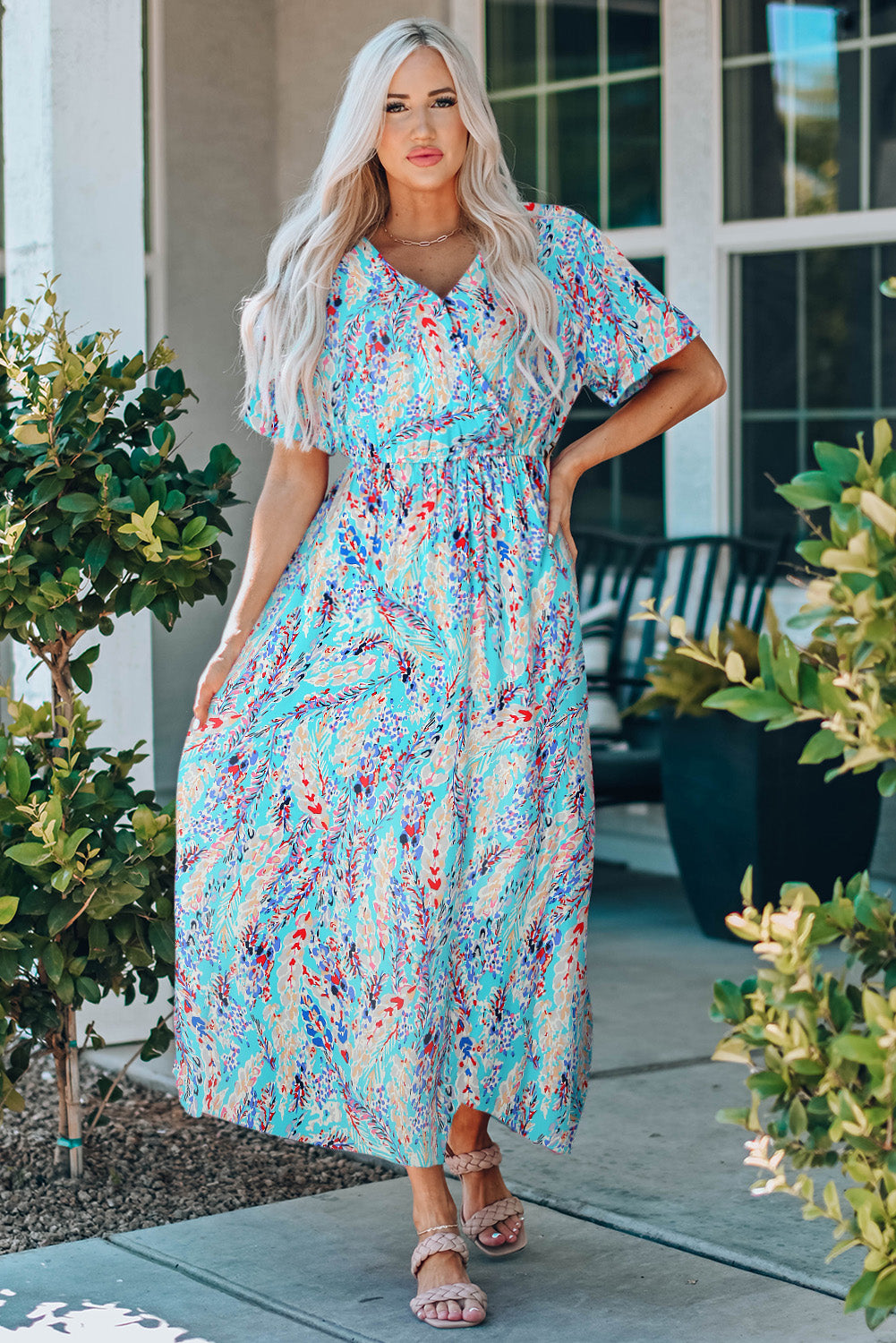 A stylish Wrap V Neck Floral Maxi Dress featuring a vibrant floral print, flutter sleeves, and a flattering wrap design, perfect for summer occasions.