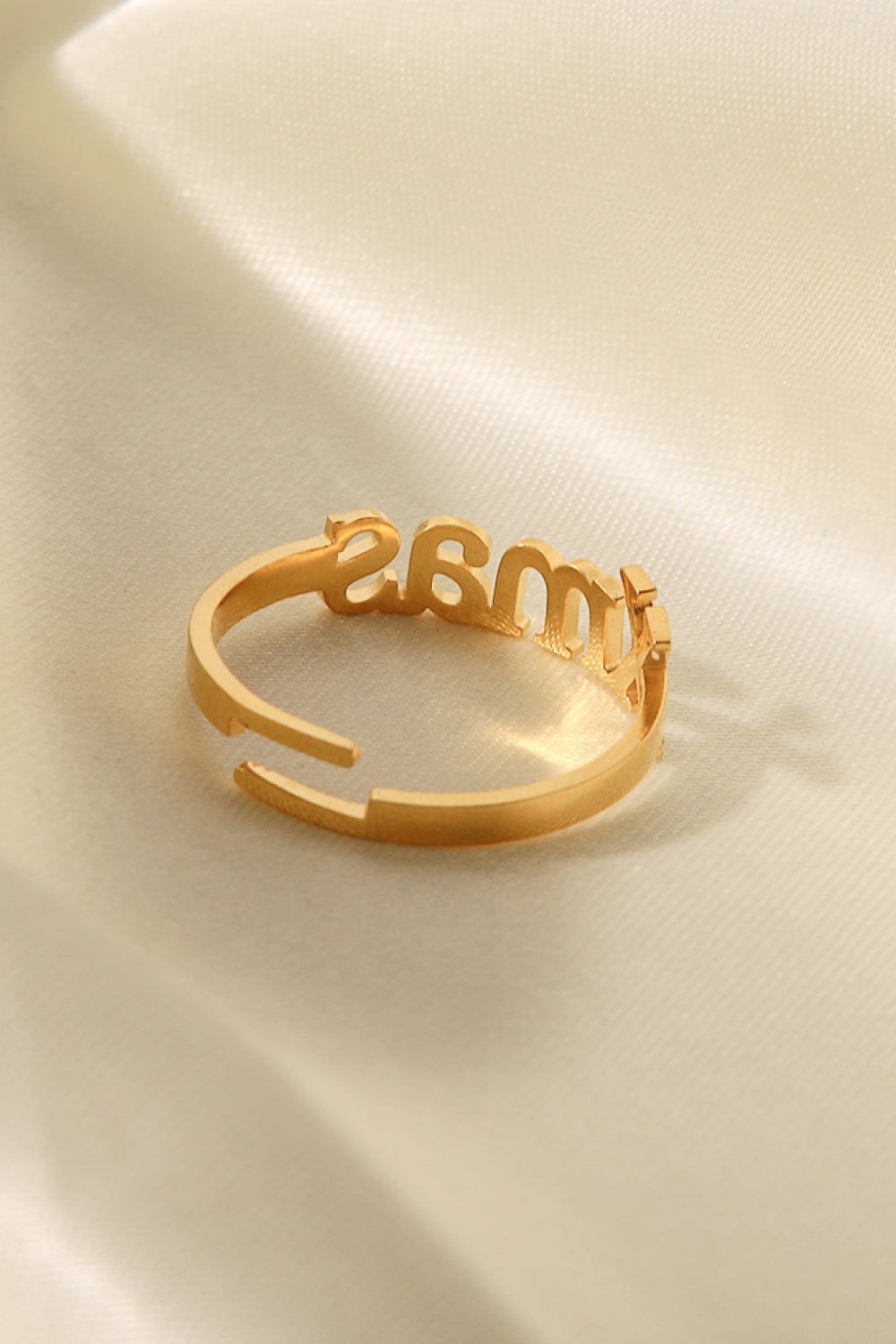 XMAS Letter Stainless Steel Ring with polished finish, showcasing its elegant design and festive motif.