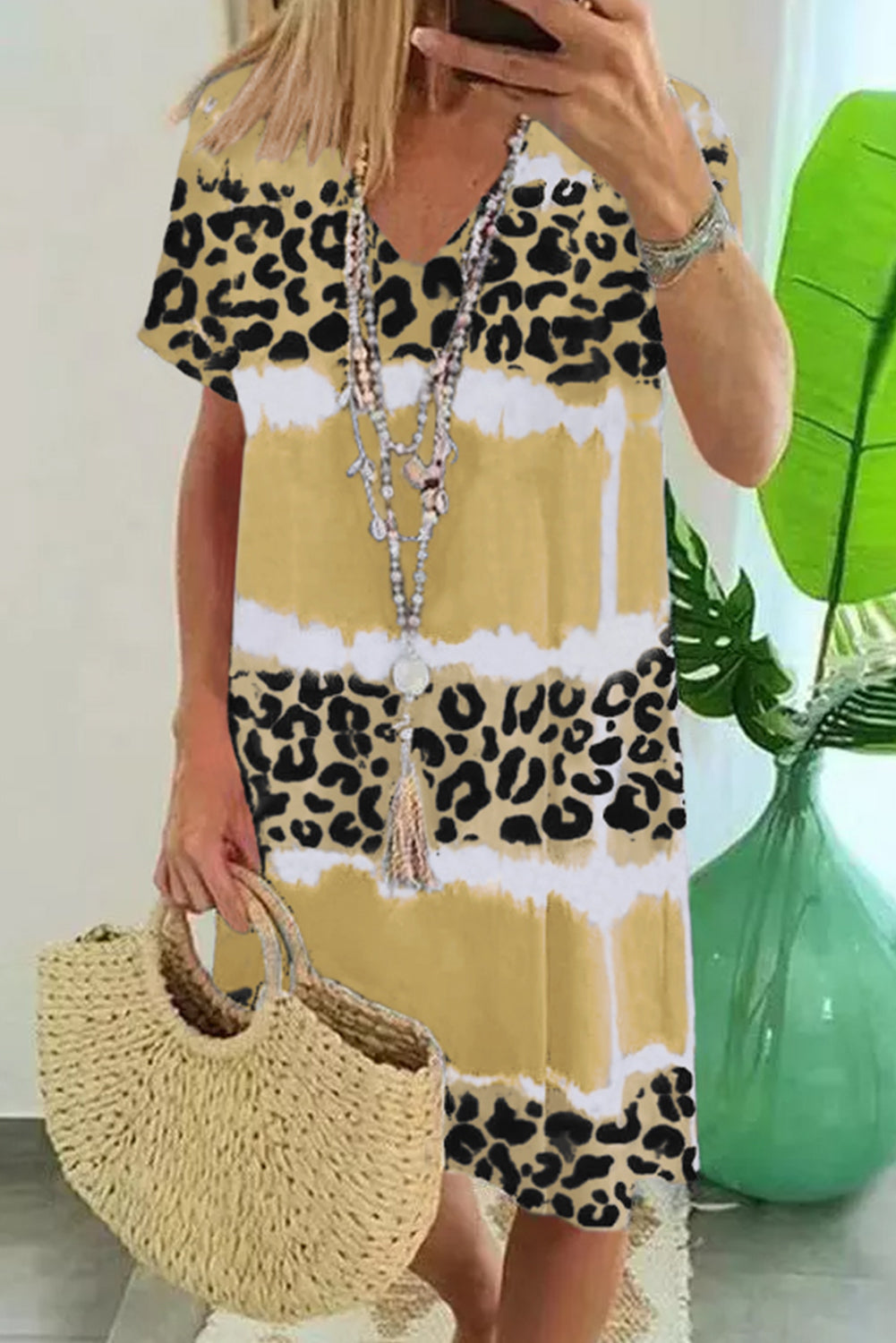 Yellow Leopard Color Block V-Neck T-shirt Dress featuring a vibrant tie-dye and leopard print pattern, short sleeves, and an A-line silhouette.