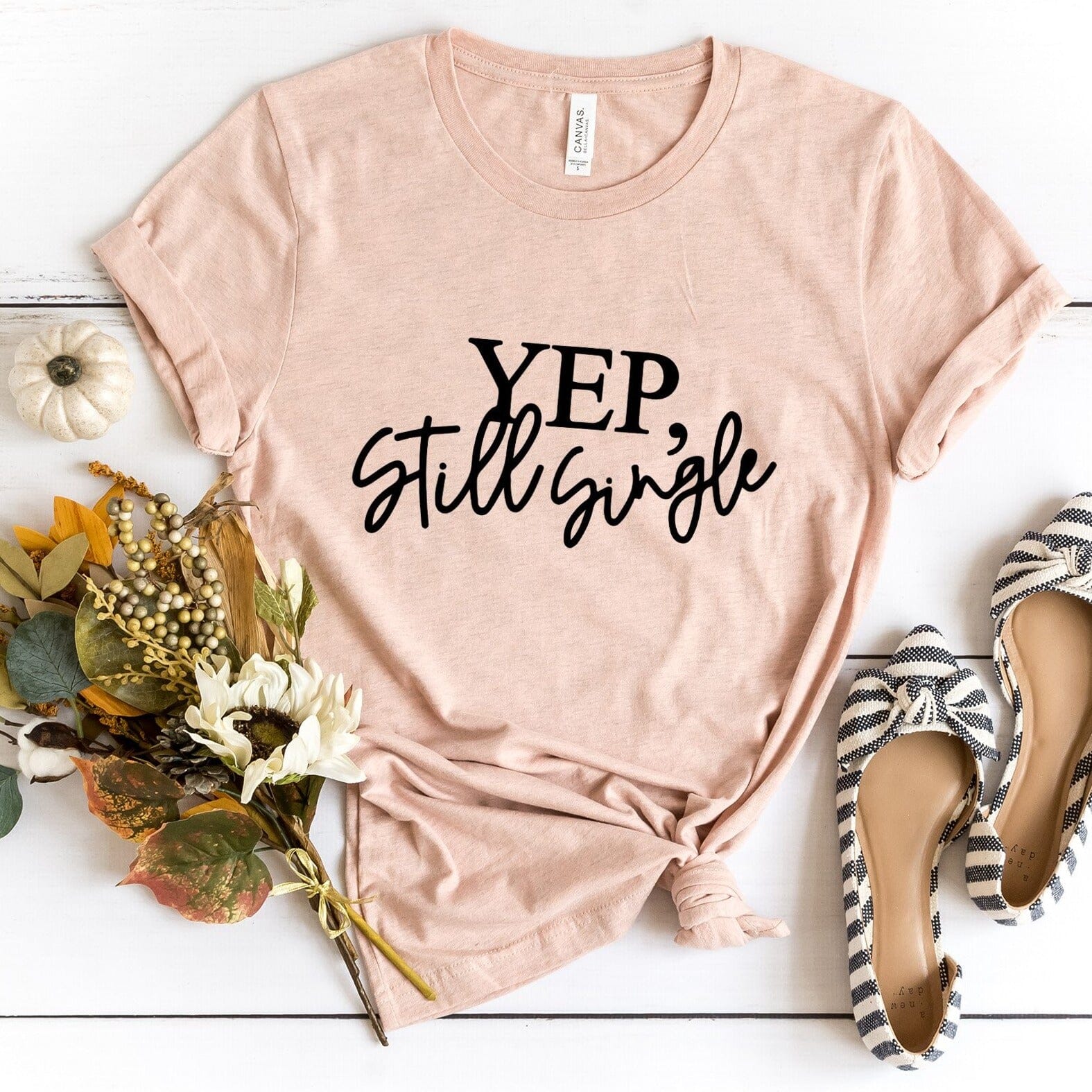 A stylish Yep, Still Single Tee in a vibrant color, showcasing its comfortable fit and humorous design, perfect for casual wear.