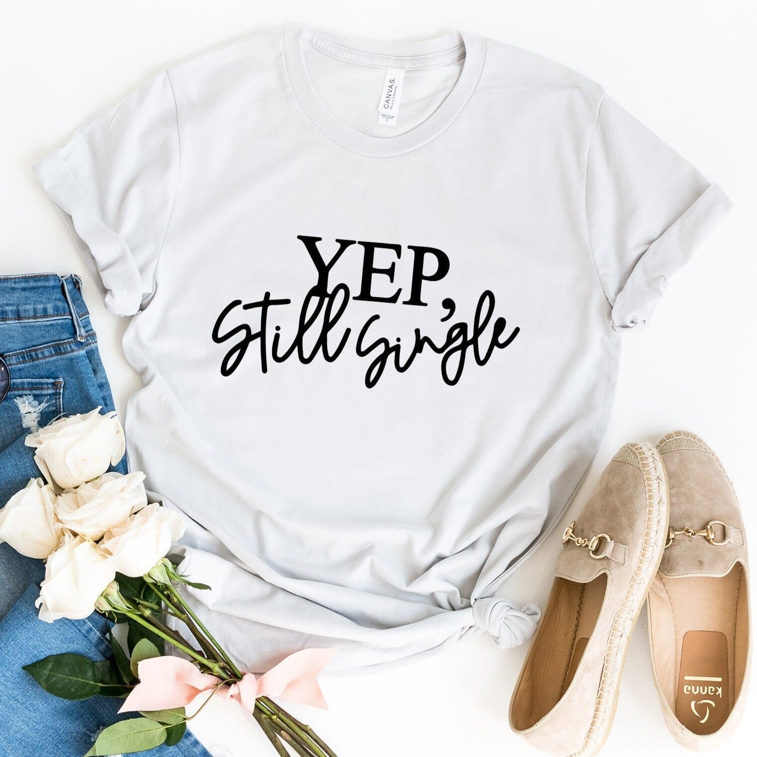 A stylish Yep, Still Single Tee in a vibrant color, showcasing its comfortable fit and humorous design, perfect for casual wear.