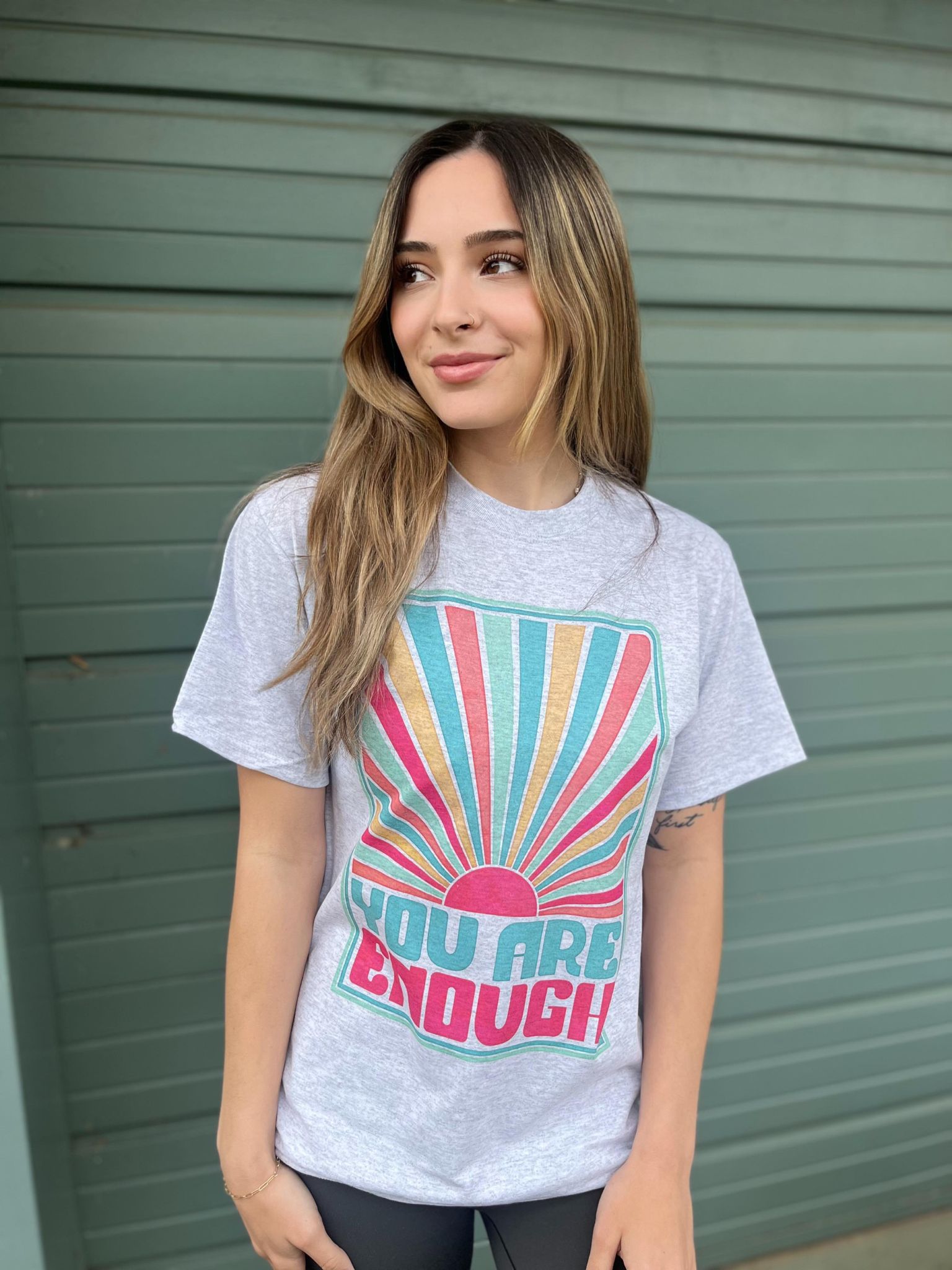 You Are Enough Tee featuring a positive message, made from a comfortable cotton-polyester blend, displayed on a model.