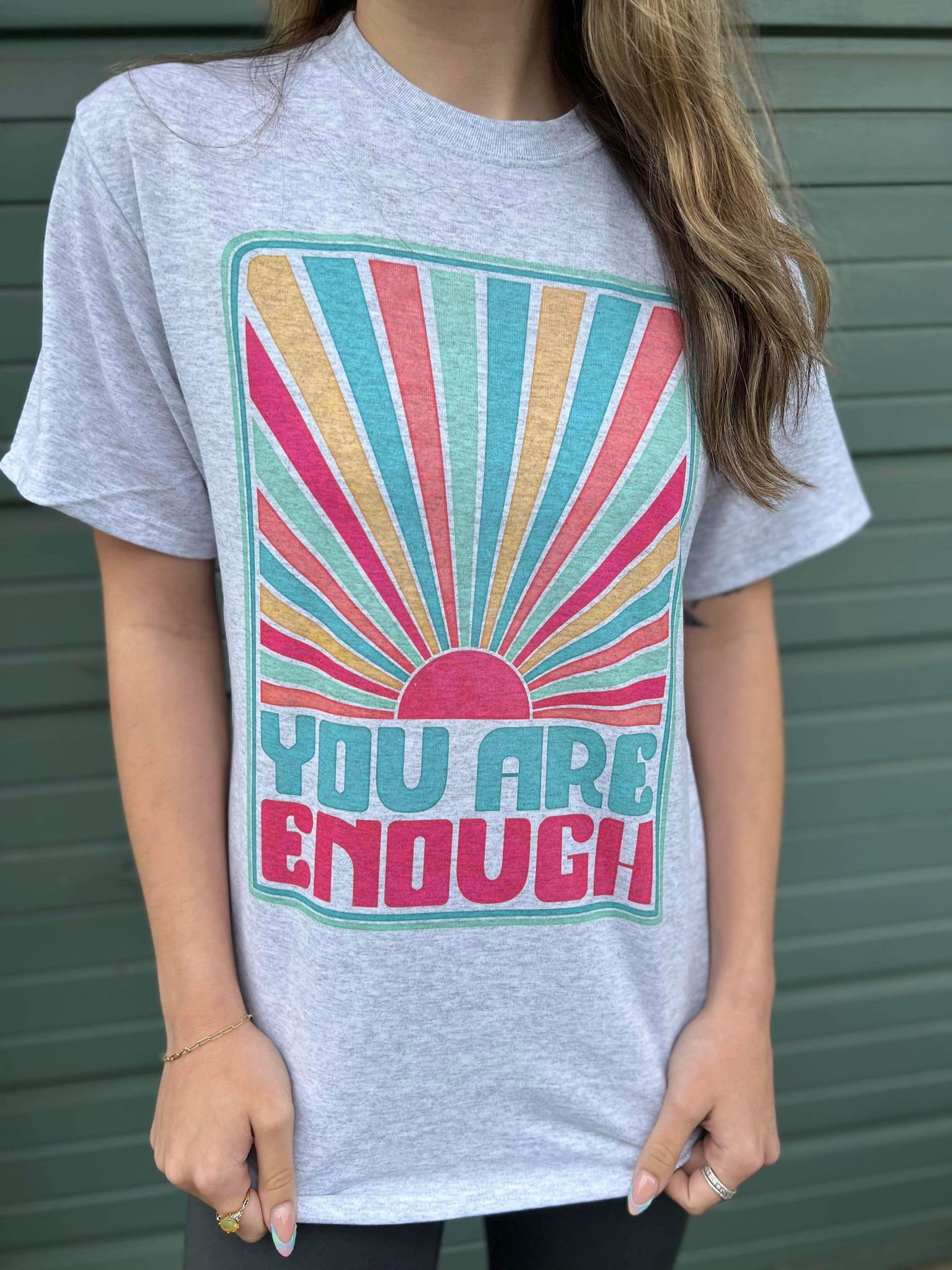 You Are Enough Tee featuring a positive message, made from a comfortable cotton-polyester blend, displayed on a model.