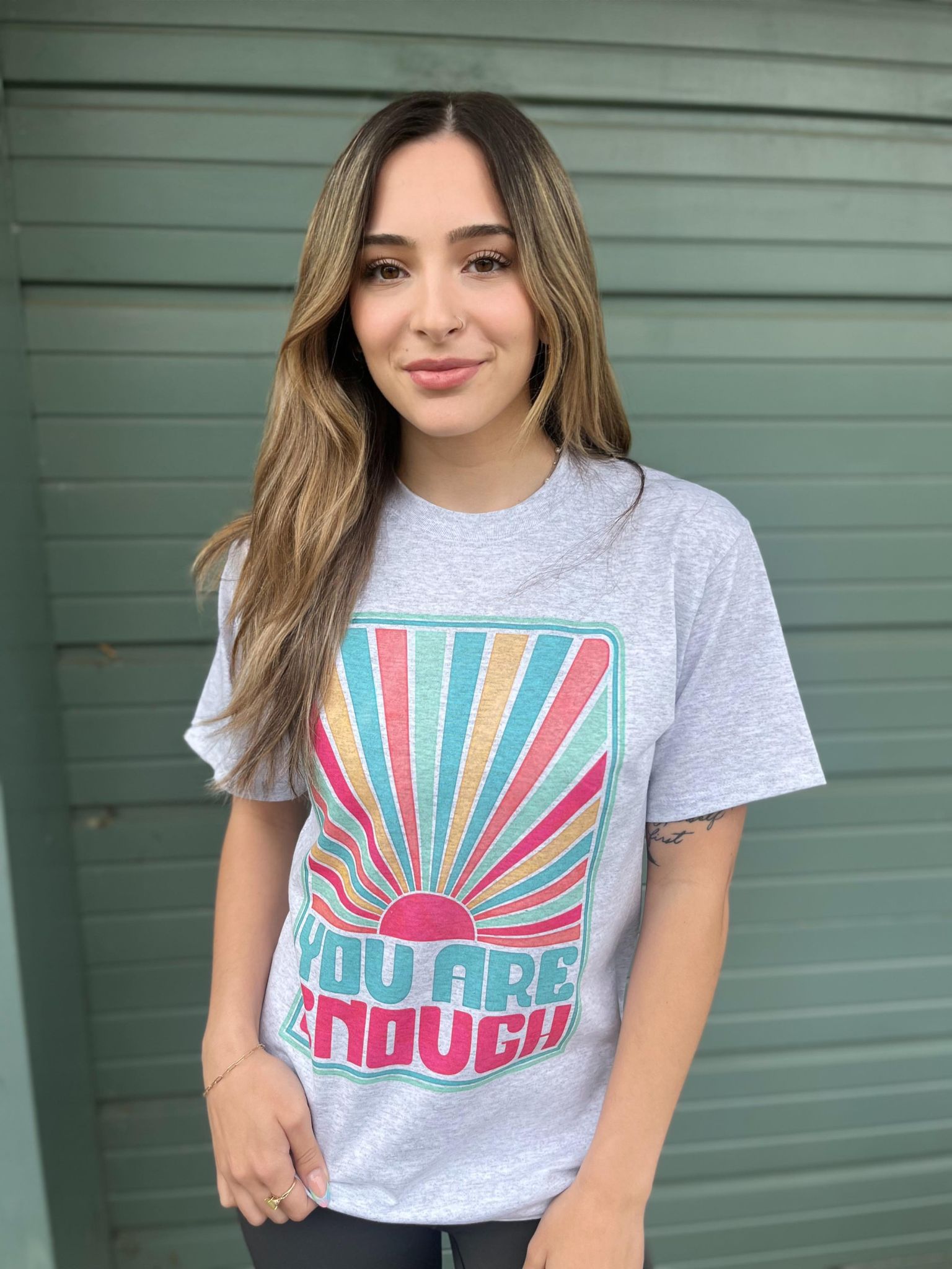 You Are Enough Tee featuring a positive message, made from a comfortable cotton-polyester blend, displayed on a model.