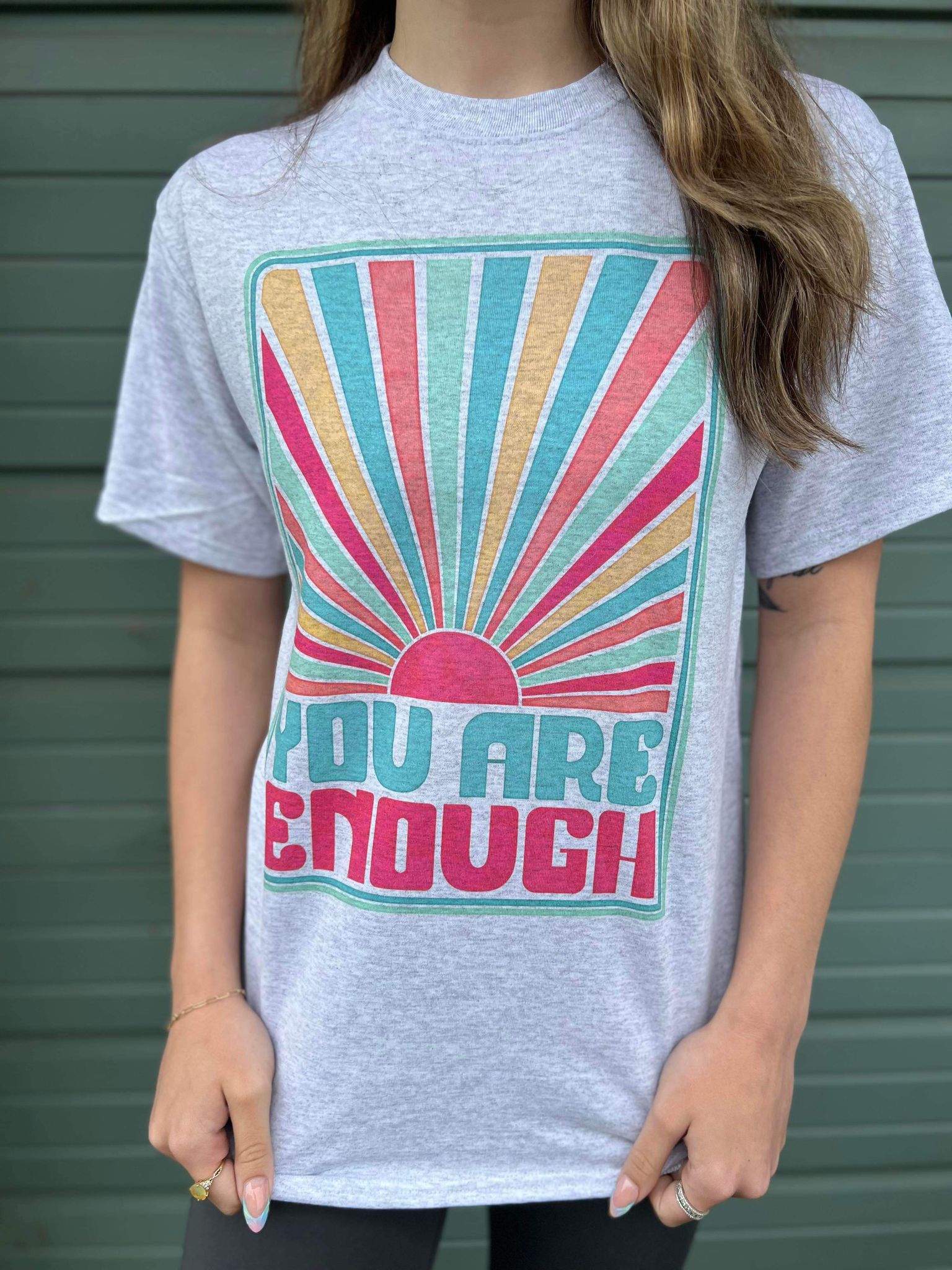 You Are Enough Tee featuring a positive message, made from a comfortable cotton-polyester blend, displayed on a model.