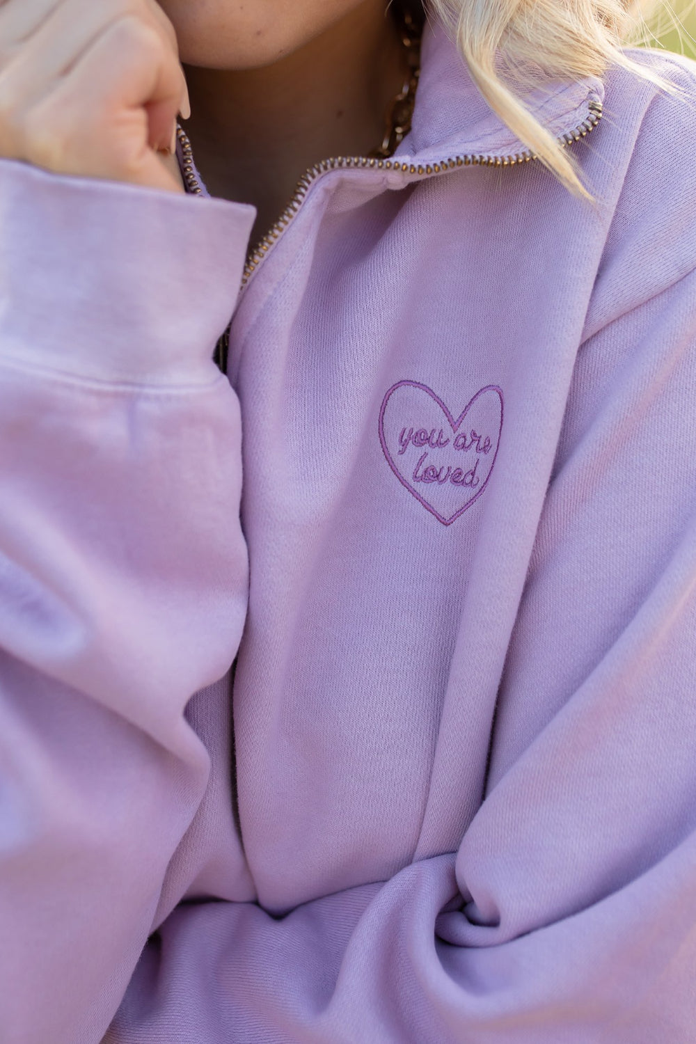 You Are Loved Half Zip Sweatshirt in coral color with heart embroidery on the left chest, showcasing a stylish half zip design.