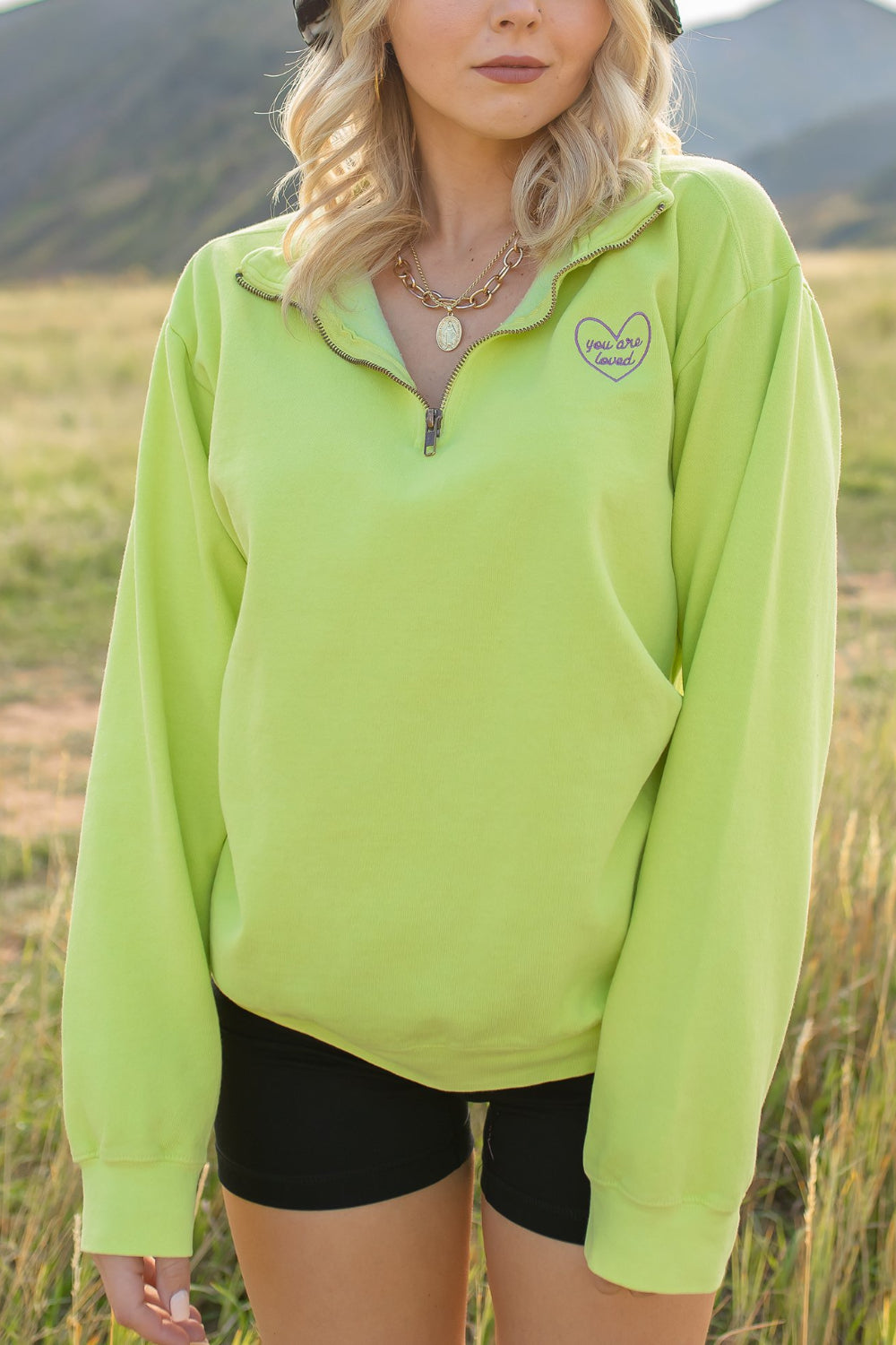 You Are Loved Half Zip Sweatshirt in coral color with heart embroidery on the left chest, showcasing a stylish half zip design.