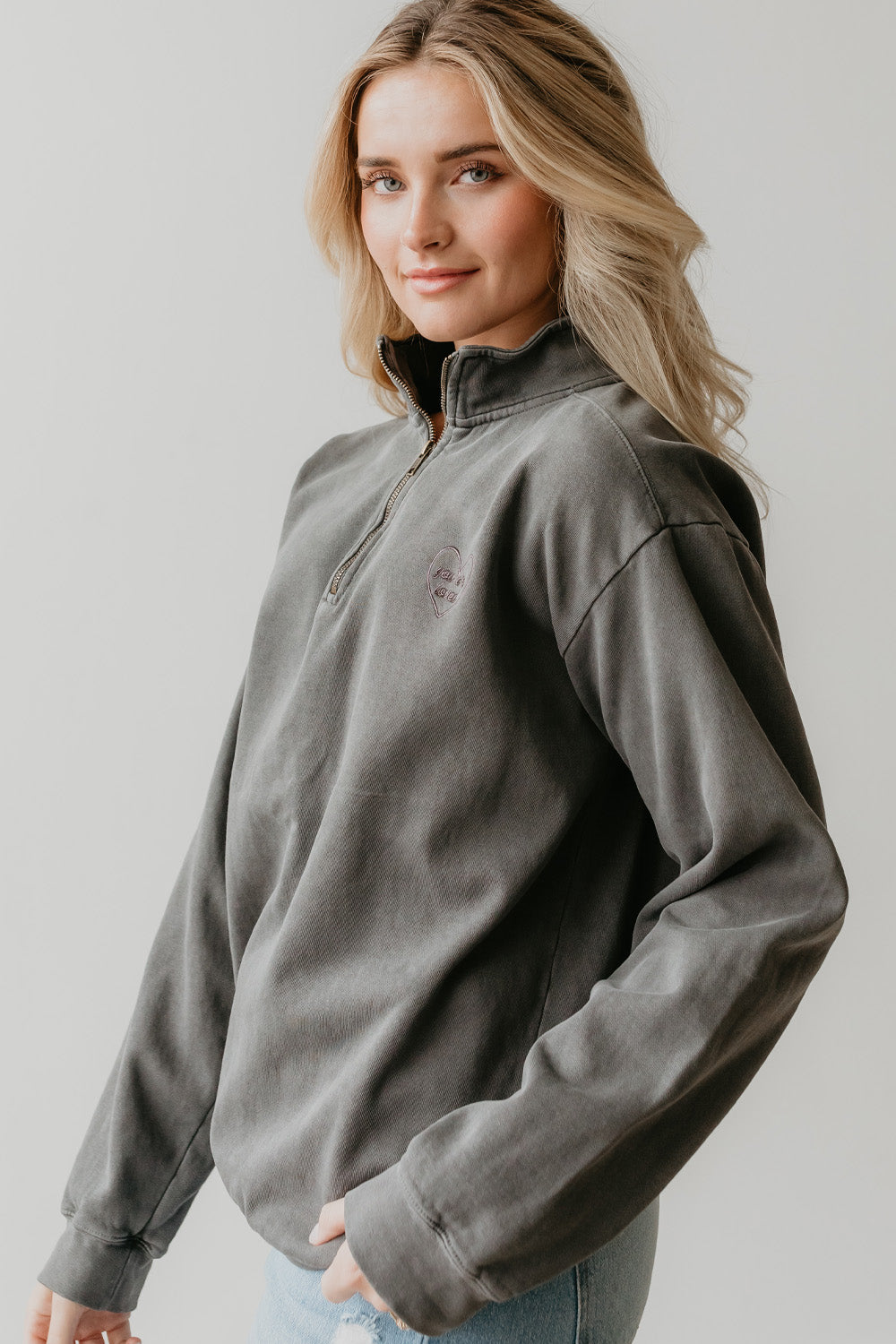 You Are Loved Half Zip Sweatshirt in coral color with heart embroidery on the left chest, showcasing a stylish half zip design.