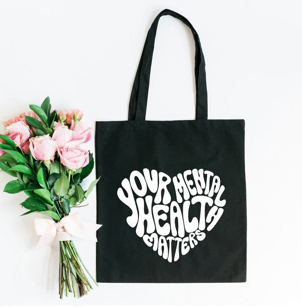 Colorful canvas tote bag with a heart design promoting mental health awareness.