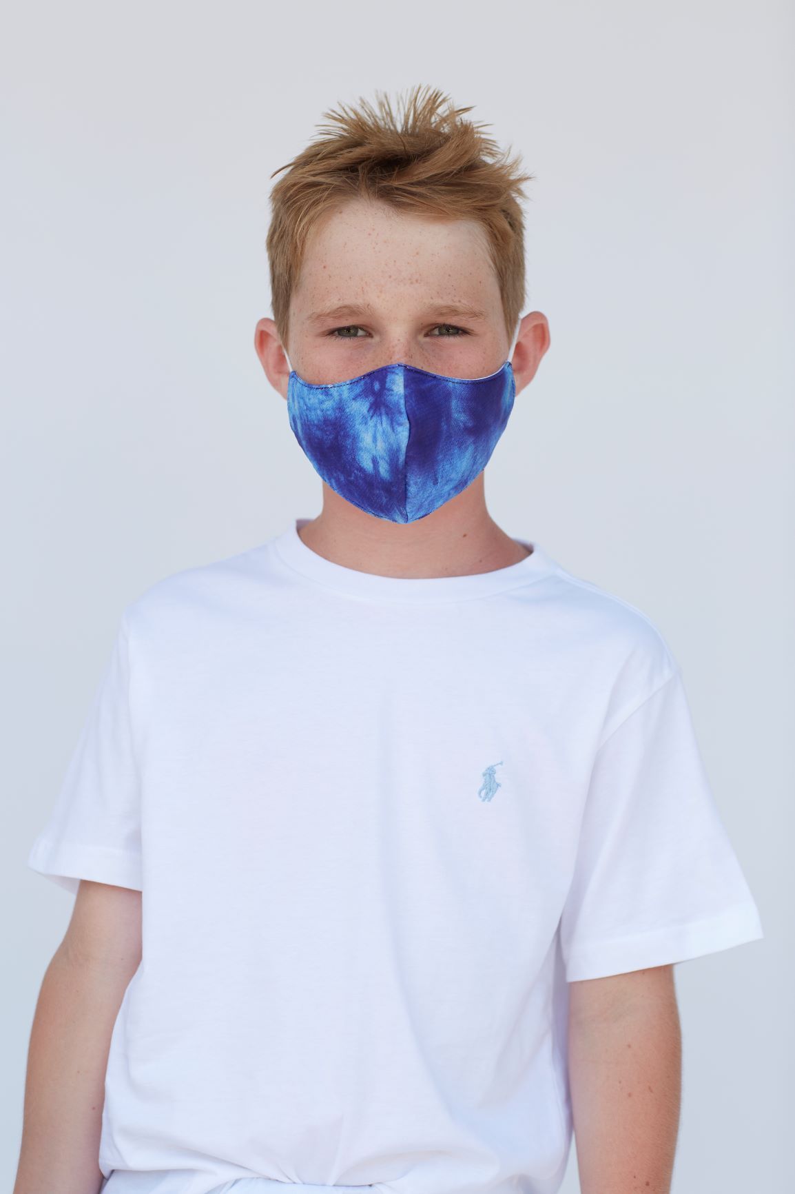 Youth Blue Tie Dye Face Mask featuring a vibrant tie dye pattern, designed for comfort and style, suitable for various outdoor activities.