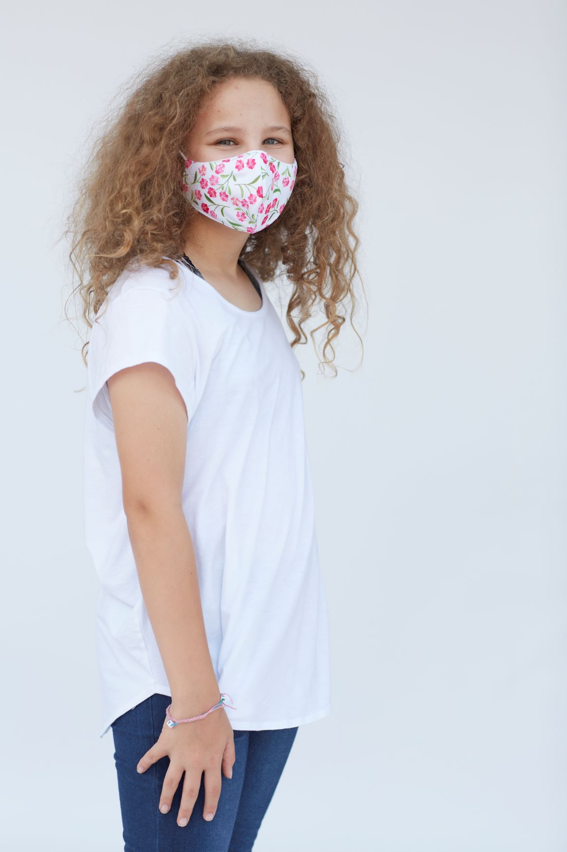 Youth Pink Roses Face Mask featuring a vibrant floral design, made of three layers for comfort and breathability.