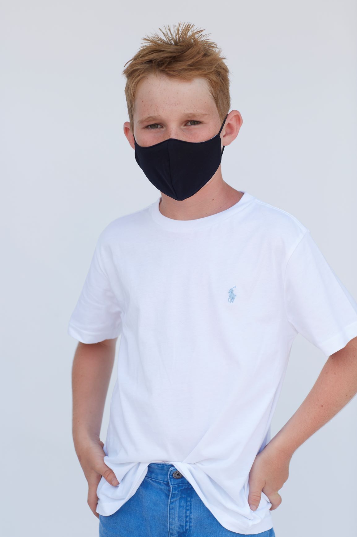 Youth Solid Black Face Mask showcasing a sleek design with adjustable ear loops, made from breathable materials for comfort.