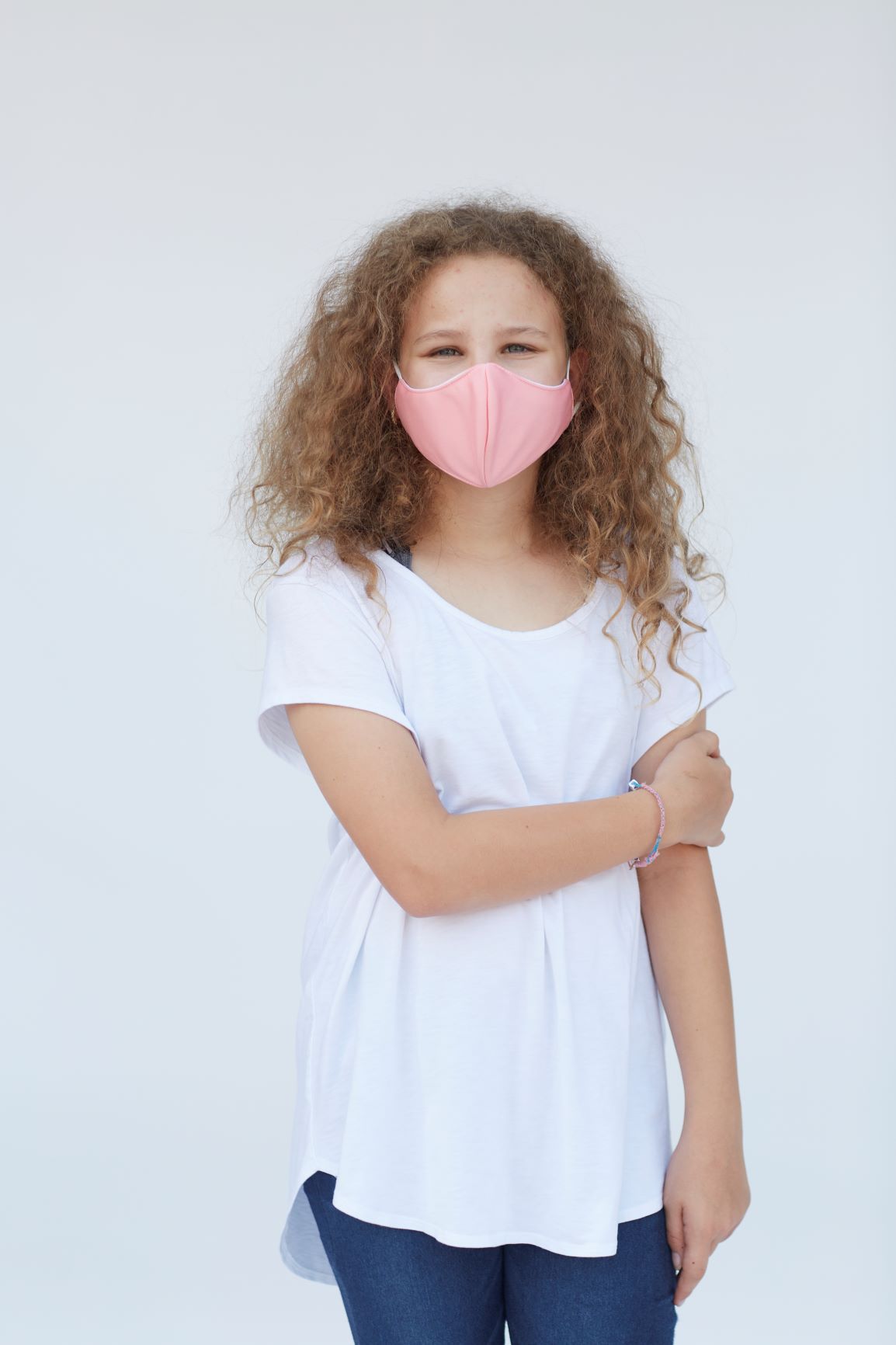 Youth Solid Light Pink Face Mask with three-layer construction, featuring a cotton inner layer and a stylish design for comfort and protection.