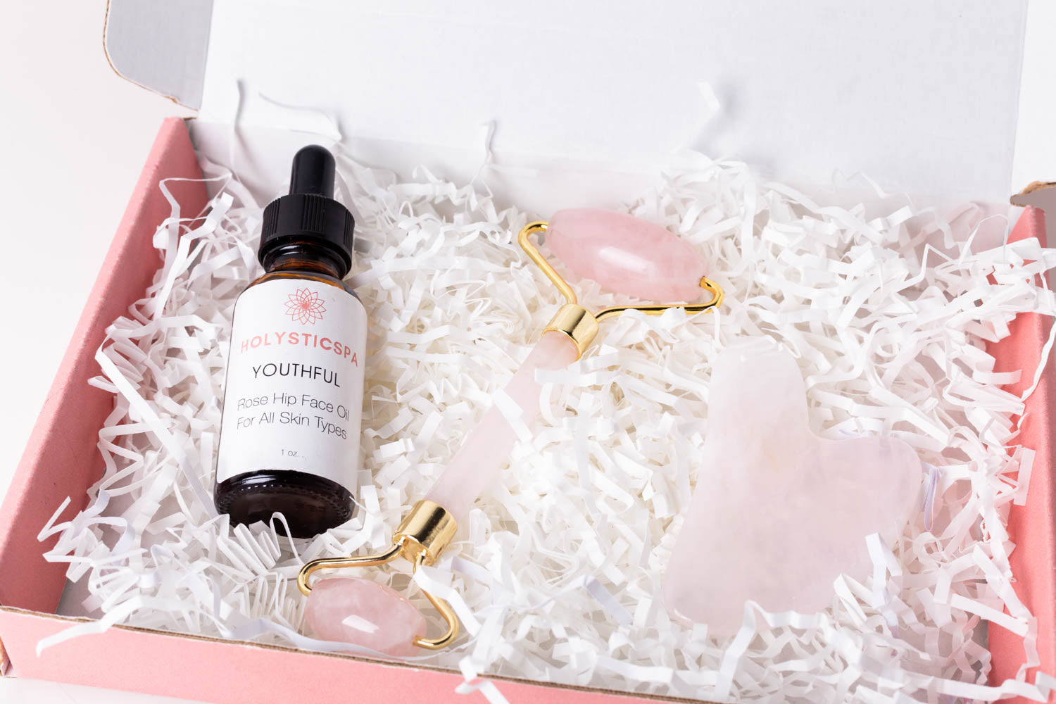 Youthful Gift Set featuring face oil, Rose Quartz roller, and Gua Sha in a beautiful gift box.