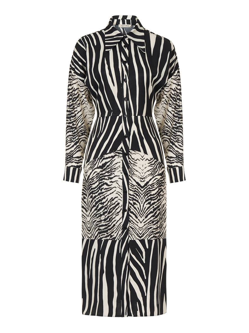 A stylish zebra print shirt dress featuring long batwing sleeves, front button closure, and slit cuffs, perfect for urban chic fashion.