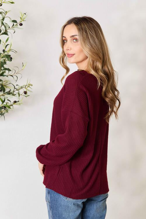 Zenana Buttoned V-Neck Long Sleeve Blouse in luxurious brushed waffle texture, featuring elegant V-neck and unique button detailing.