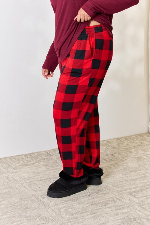 Zenana Full Size Plaid Round Neck Top and Pants Pajama Set featuring a stylish plaid design, front pocket, and drawstring elastic waist pants.