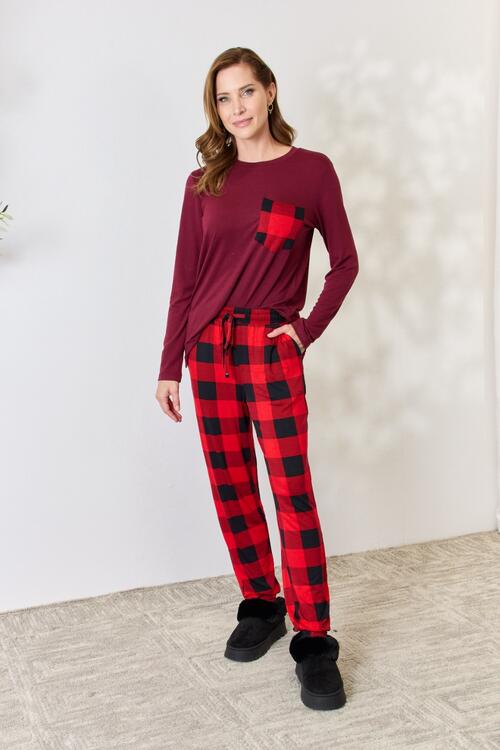 Zenana Full Size Plaid Round Neck Top and Pants Pajama Set featuring a stylish plaid design, front pocket, and drawstring elastic waist pants.