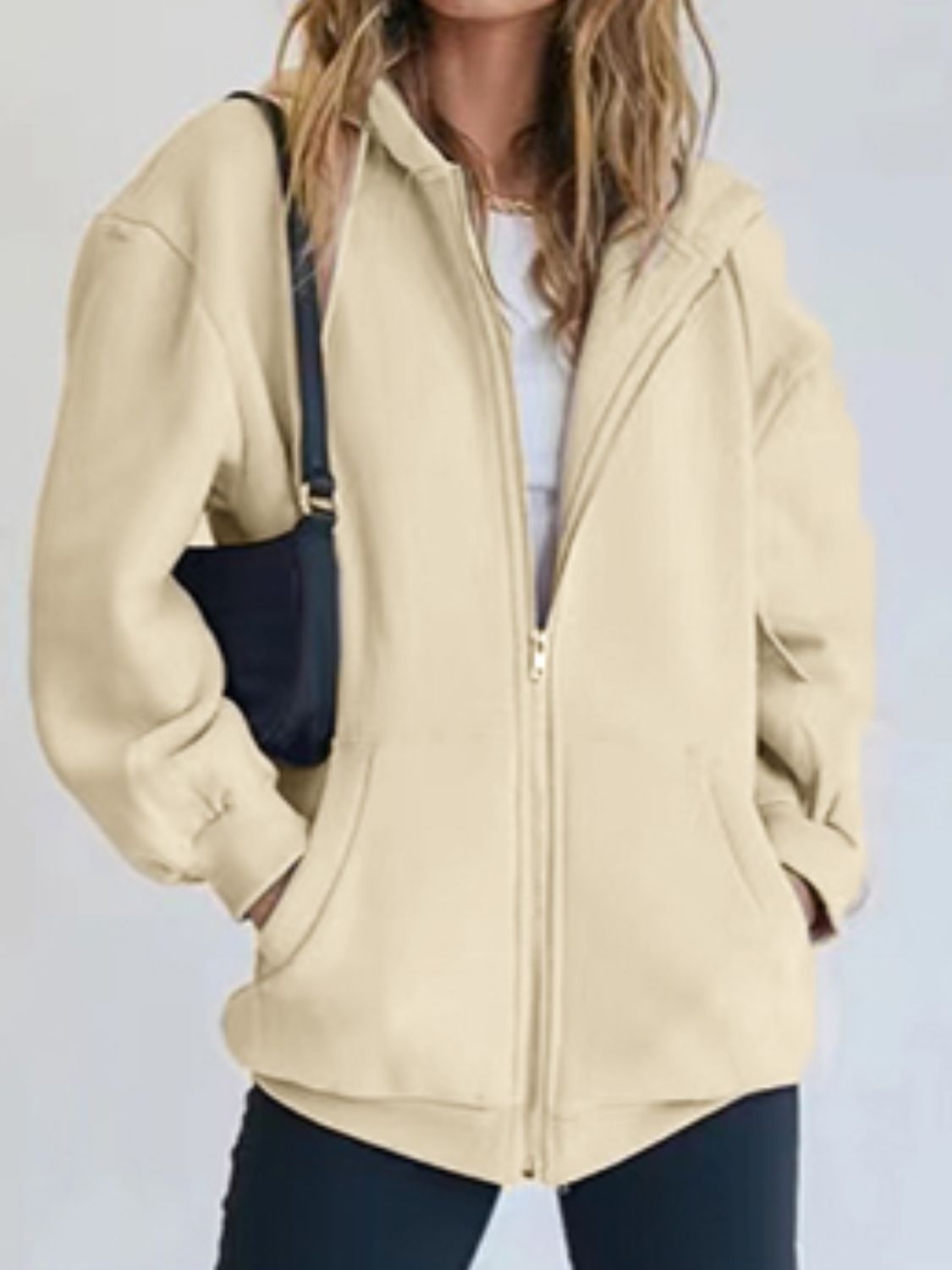 A stylish Zip-Up Drawstring Hoodie in solid color, featuring a hood, long sleeves, and pockets, perfect for casual wear.