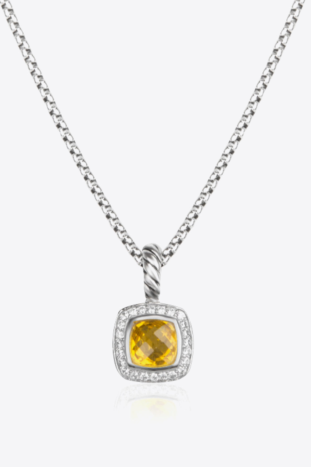 A modern Zircon Pendant Copper Necklace featuring a minimalist design, showcasing a twisted and polished zircon pendant on an 18k platinum-plated chain.