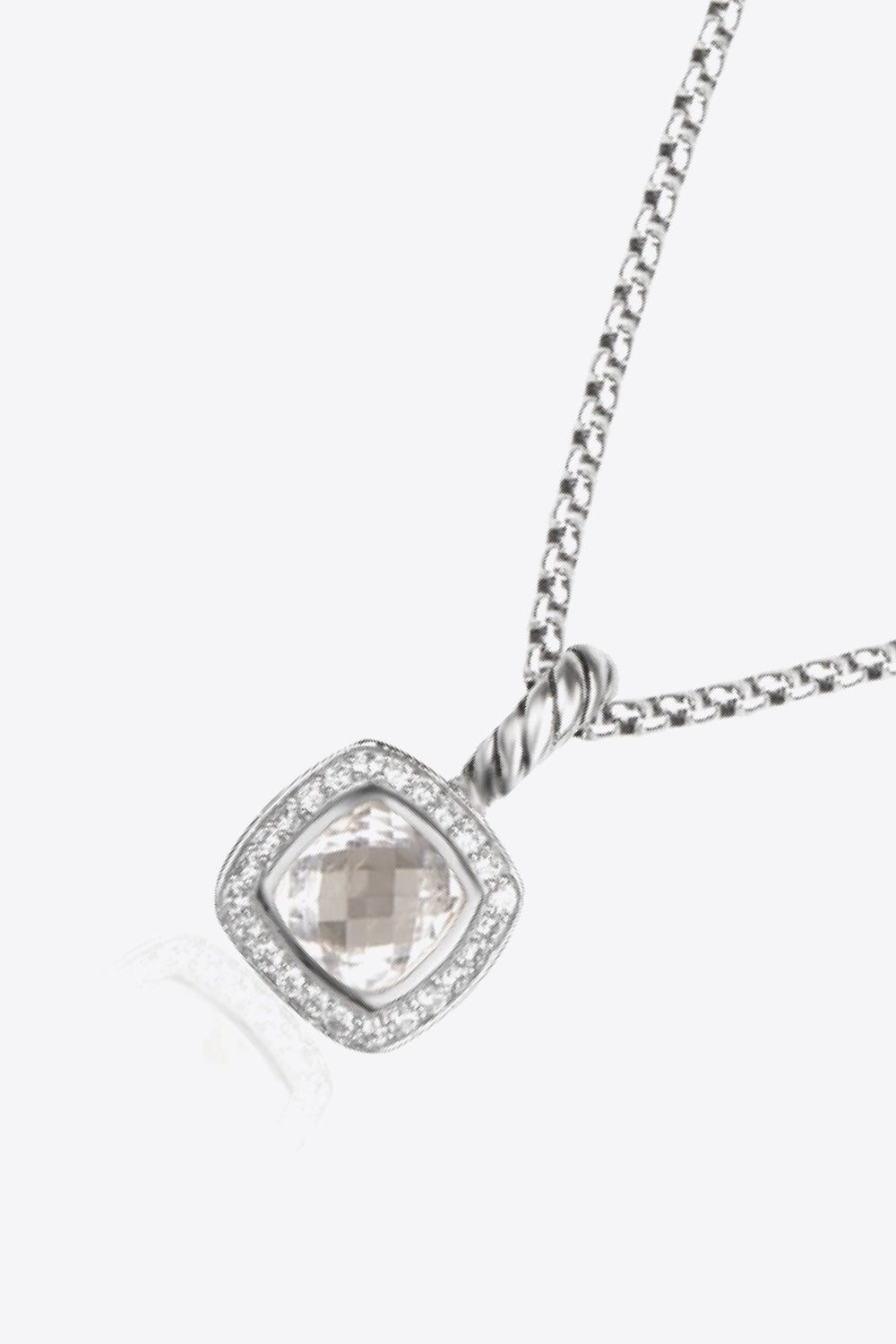 A modern Zircon Pendant Copper Necklace featuring a minimalist design, showcasing a twisted and polished zircon pendant on an 18k platinum-plated chain.